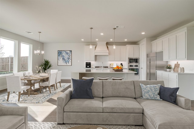 living room with light hardwood / wood-style floors and a chandelier