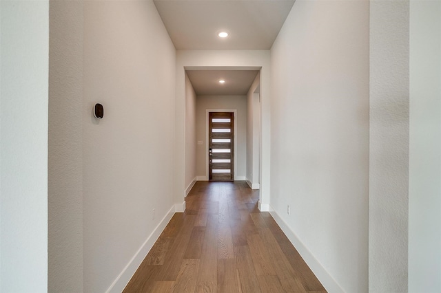 corridor featuring hardwood / wood-style floors