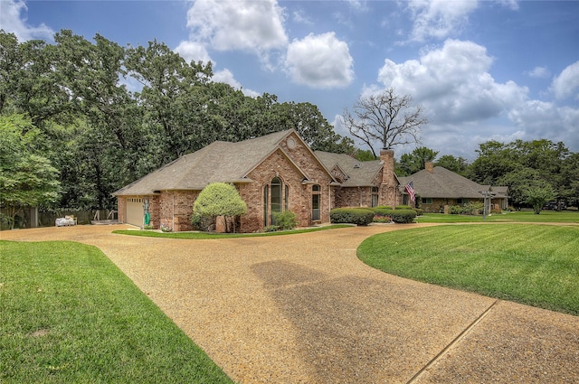 view of front facade with a garage and a front lawn