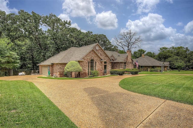 view of front of property featuring a garage and a front lawn