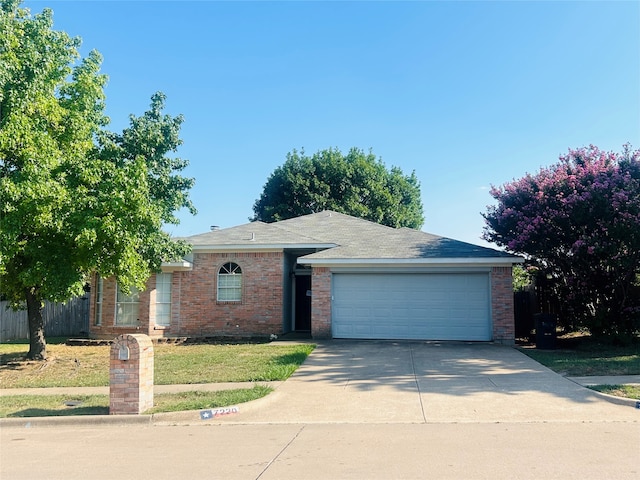 ranch-style house with a garage and a front lawn