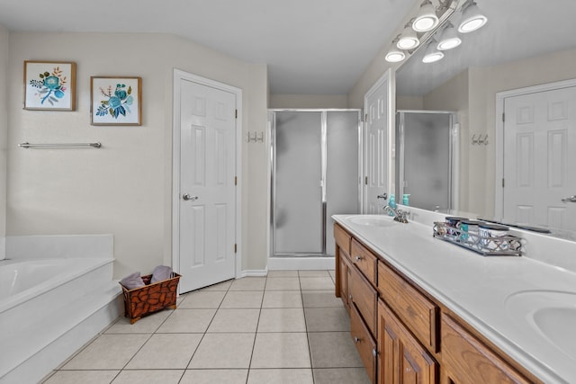 bathroom with shower with separate bathtub, double sink vanity, and tile patterned flooring