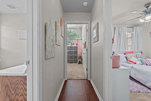 hallway with hardwood / wood-style floors