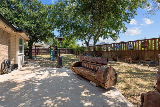 exterior space with a playground and a patio