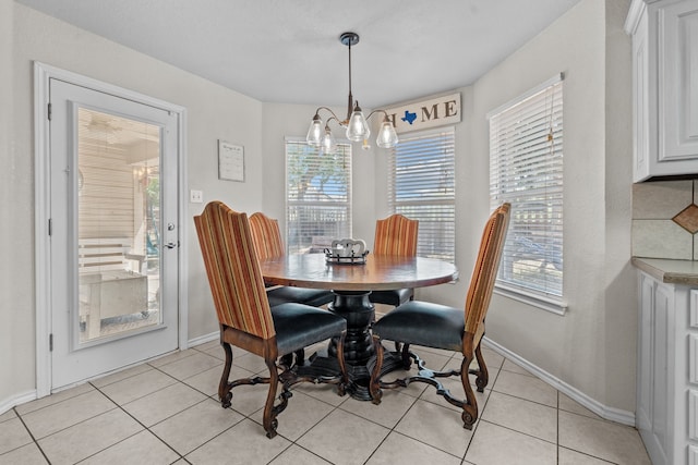 dining area featuring a notable chandelier and light tile patterned floors