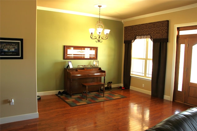 interior space featuring hardwood / wood-style flooring, crown molding, and a chandelier