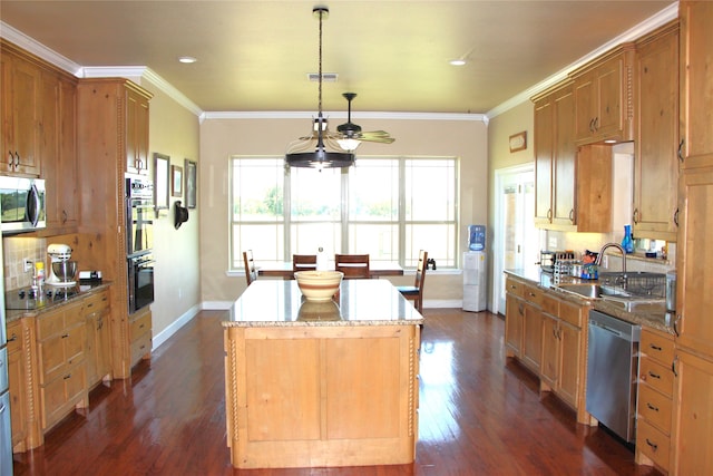 kitchen featuring ceiling fan, dark hardwood / wood-style floors, a kitchen island, black appliances, and crown molding