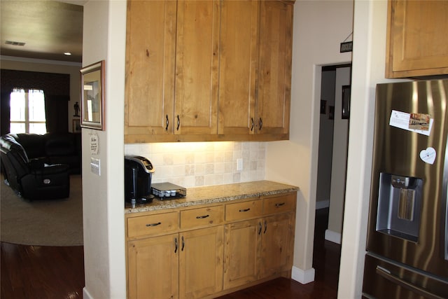 kitchen featuring stainless steel fridge with ice dispenser, dark hardwood / wood-style floors, decorative backsplash, and light stone counters