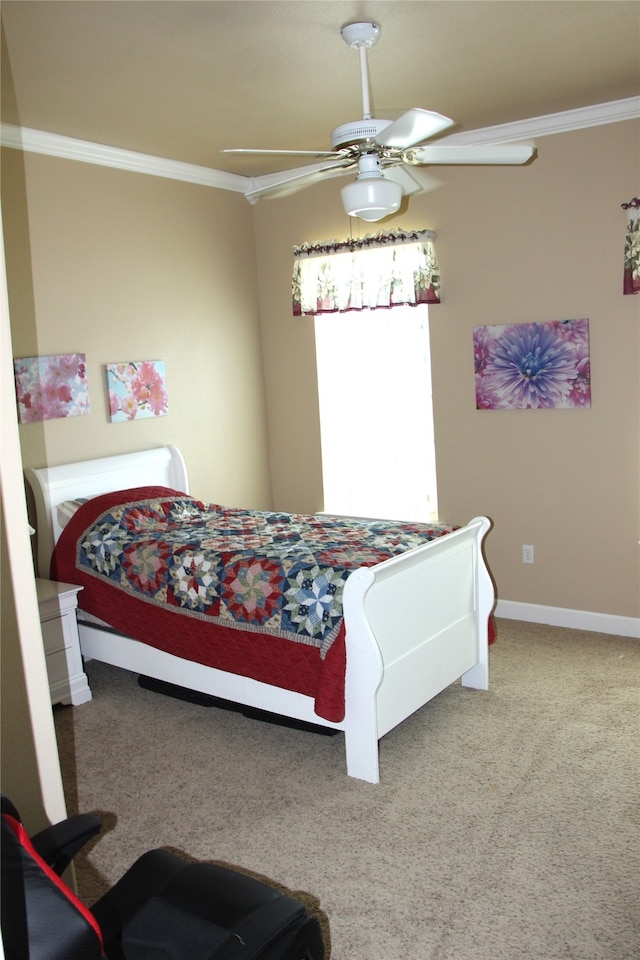 carpeted bedroom featuring ceiling fan and ornamental molding