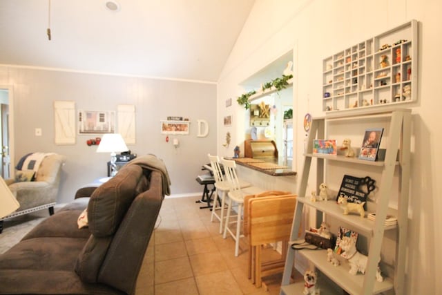 living room with vaulted ceiling and light tile patterned floors