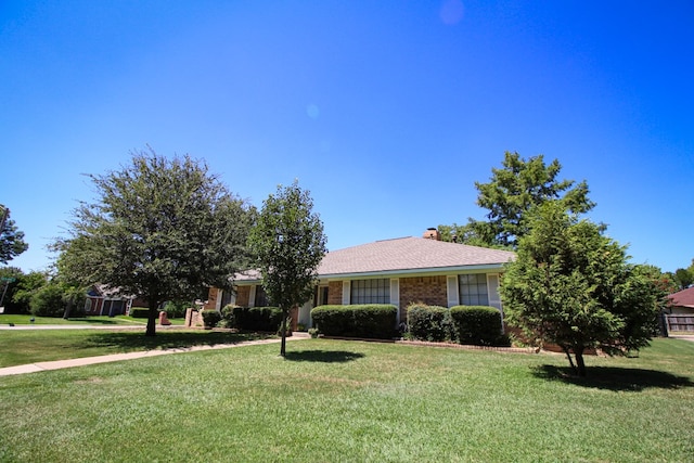 ranch-style home featuring a front yard