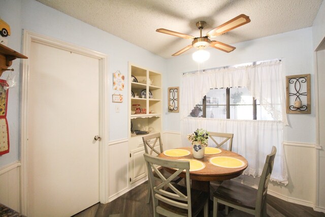 dining room featuring built in features, ceiling fan, a textured ceiling, and dark hardwood / wood-style flooring