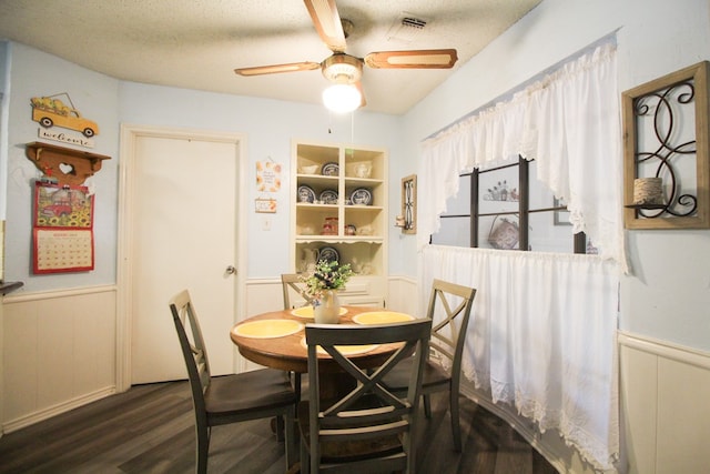 dining room featuring a textured ceiling, wood-type flooring, and ceiling fan