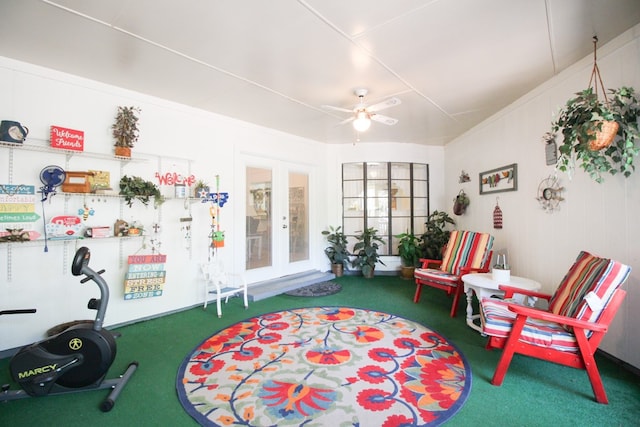 sitting room with carpet flooring, french doors, and ceiling fan