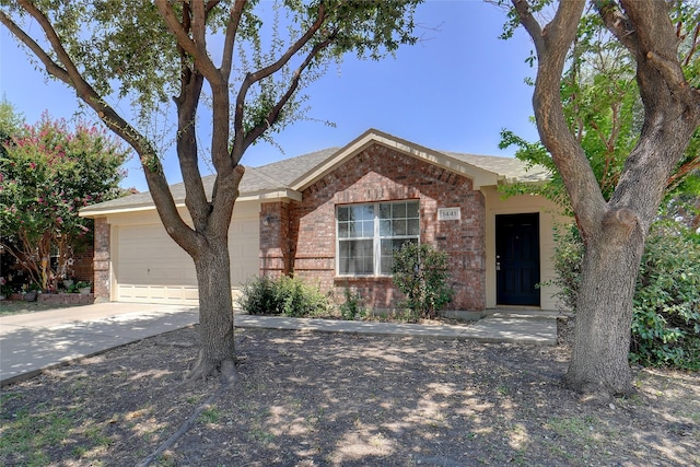 ranch-style home with brick siding, driveway, and a garage