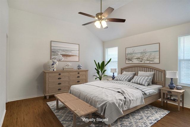 bedroom featuring a ceiling fan, lofted ceiling, wood finished floors, and baseboards