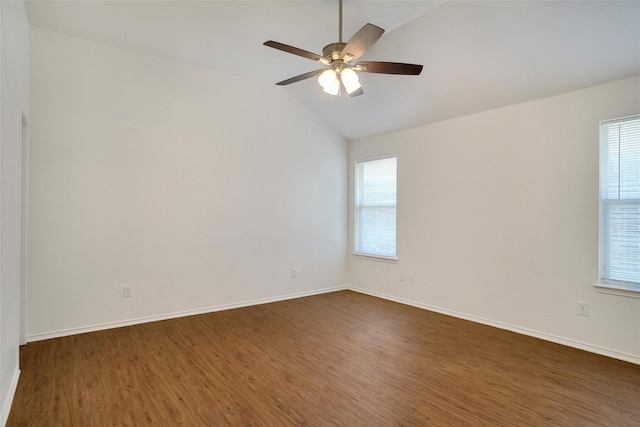 spare room with dark wood finished floors, a ceiling fan, and baseboards