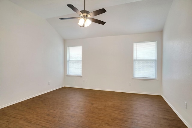 spare room with ceiling fan, baseboards, dark wood finished floors, and vaulted ceiling