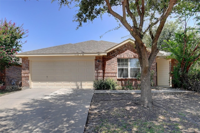 ranch-style home with brick siding, concrete driveway, a garage, and a shingled roof