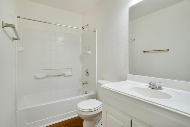 bathroom with washtub / shower combination, toilet, vanity, and wood finished floors