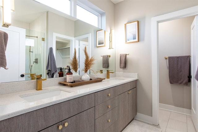 bathroom with a shower with shower door, tile patterned floors, and double sink vanity