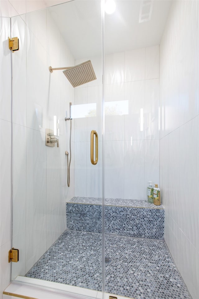 bathroom featuring a shower with shower door