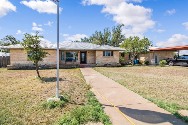 ranch-style home with a front lawn and a carport