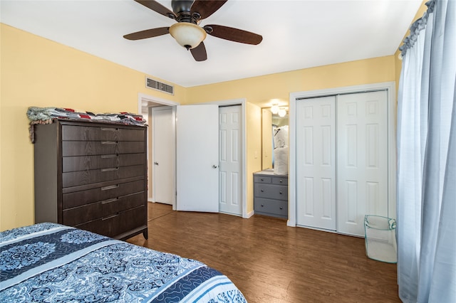 bedroom featuring ceiling fan, two closets, and hardwood / wood-style flooring