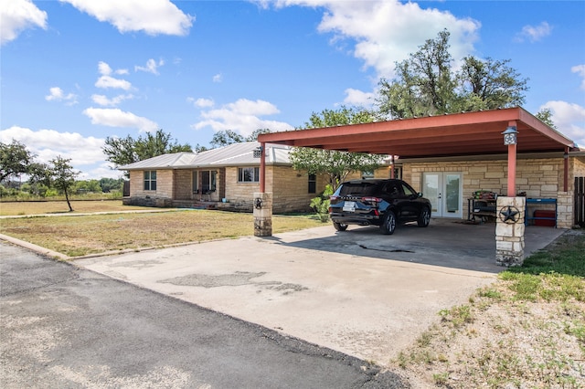 view of vehicle parking featuring a carport and a yard