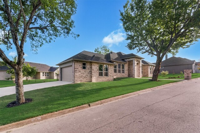 view of front of home featuring a garage and a front lawn