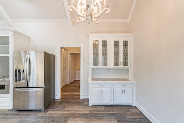 unfurnished dining area featuring an inviting chandelier, dark hardwood / wood-style floors, lofted ceiling, and ornamental molding