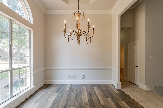 unfurnished living room with a fireplace, a healthy amount of sunlight, hardwood / wood-style floors, and a high ceiling