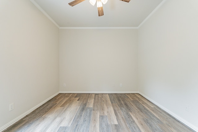 spare room featuring high vaulted ceiling, crown molding, and wood-type flooring