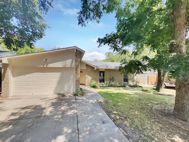 ranch-style house with a garage and a front yard