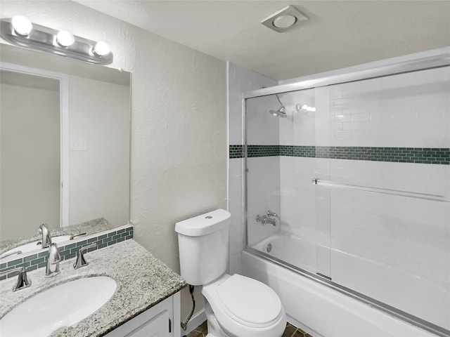 full bathroom with vanity, toilet, and combined bath / shower with glass door