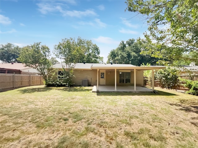 back of house with a patio area and a lawn