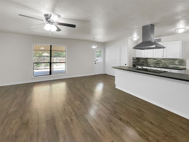 kitchen featuring ceiling fan, dark hardwood / wood-style floors, tasteful backsplash, and island exhaust hood