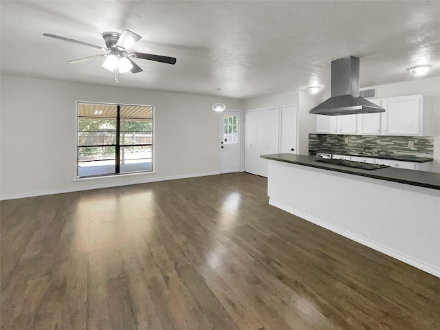 kitchen featuring tasteful backsplash, black electric stovetop, island exhaust hood, dark hardwood / wood-style flooring, and white cabinetry