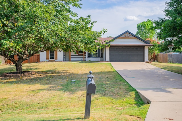 view of front of house featuring a garage and a front lawn