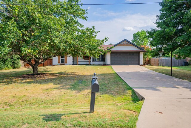 obstructed view of property with a garage and a front yard