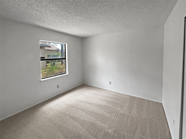 carpeted empty room with a textured ceiling