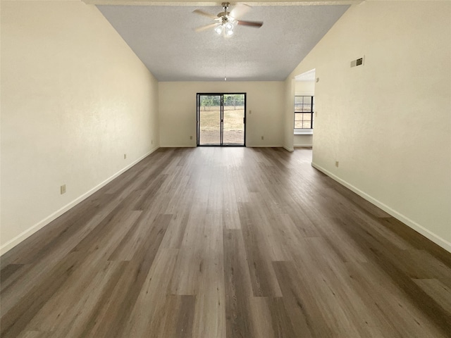 interior space with ceiling fan, wood-type flooring, high vaulted ceiling, and a textured ceiling