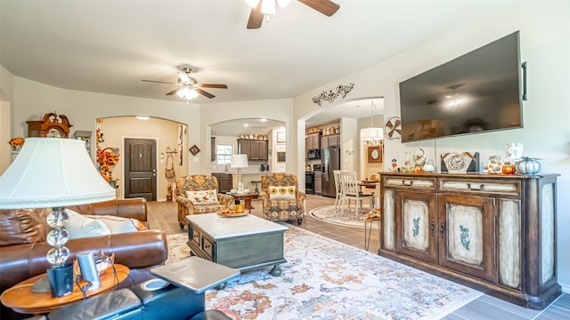 living room with ceiling fan and dark hardwood / wood-style floors