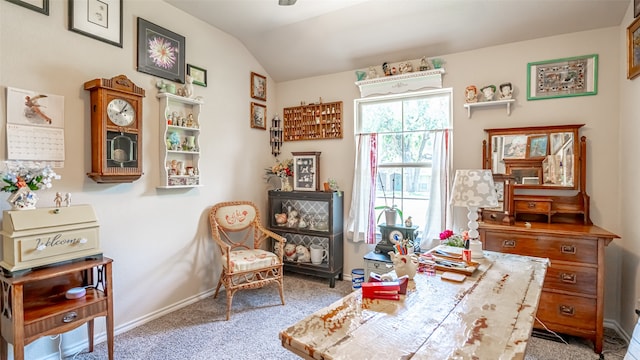 living area with carpet floors and vaulted ceiling