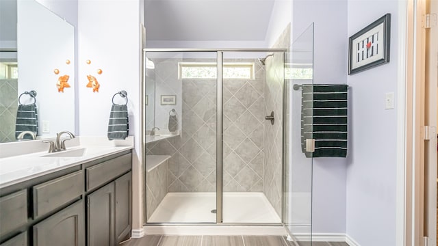 bathroom featuring hardwood / wood-style flooring, vanity, and a shower with shower door