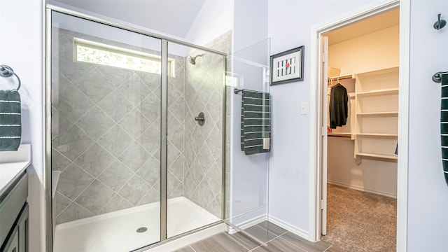 bathroom with an enclosed shower, vaulted ceiling, and vanity