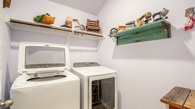 clothes washing area featuring independent washer and dryer