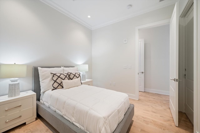 bedroom with crown molding and light wood-type flooring