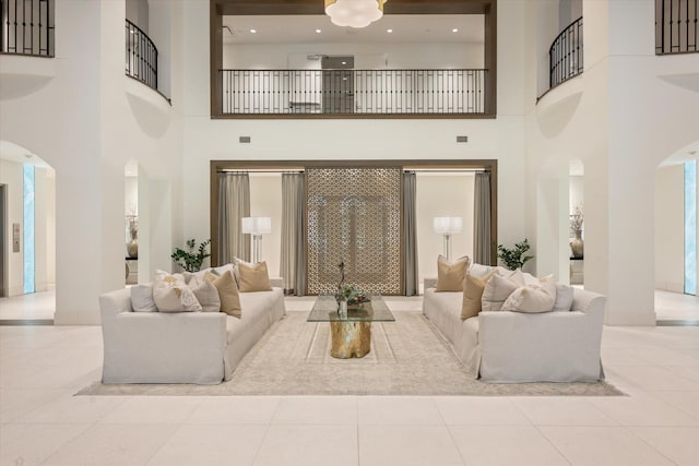 tiled living room featuring a towering ceiling