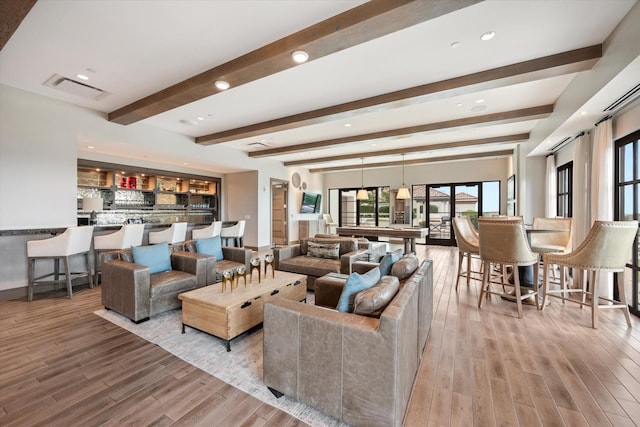 living room featuring beam ceiling and light wood-type flooring